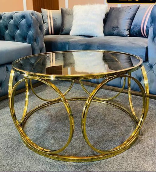 Glass table with honey-colored stainless steel